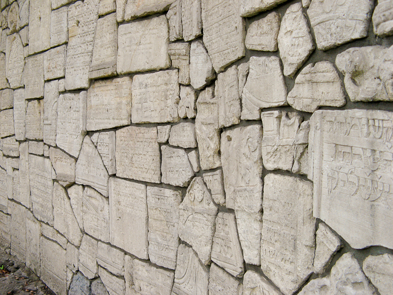 Wall of broken Jewish grave stones in Krakow Poland.