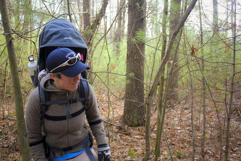 Jen carrying Addie through the orienteering course