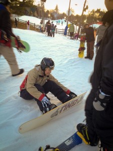 Taking a break to adjust my bindings while snowboarding at Pat's Peak.