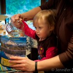 Addie pouring water into the Mountain House Mountain Oven.