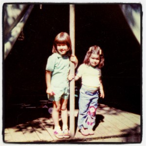 My sister and me posing outside our tent at family camp.