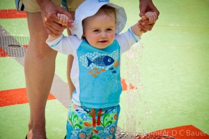 Addie splashing in the children's water fountains at Falls Park in Greenville, S.C.