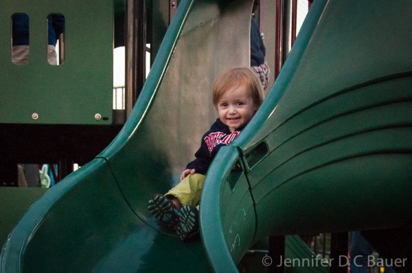 Addie playing on the playground at Fluor Field.