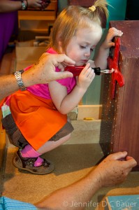 Addie learning how to use a screwdriver at the Children's Museum in Boston, MA.