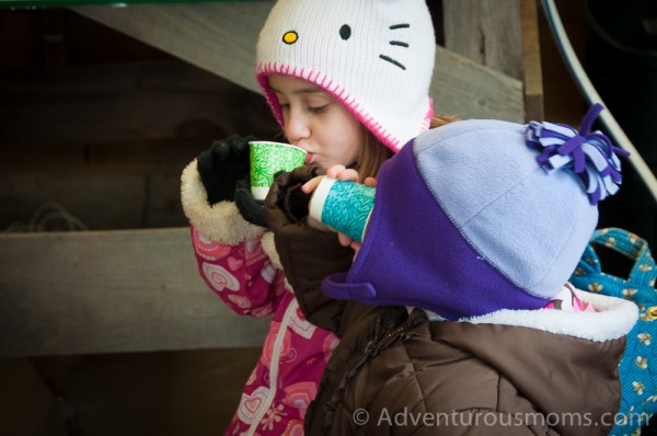 Addie and Elizabeth sampling freshly made maple syrup at Appleton Farms in Ipswich, MA