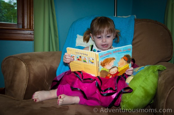 Addie reading, "Mommy, Mama, and Me."