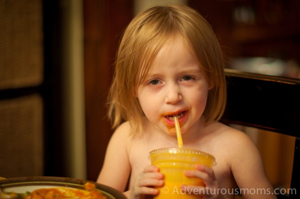 Addie enjoying a mango lassi with her chicken tikka masala.