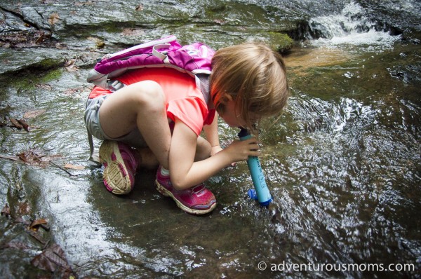 Addie using a  LifeStraw Personal Water Filter