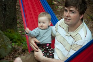 Mark and Addie relaxing on a hammock.