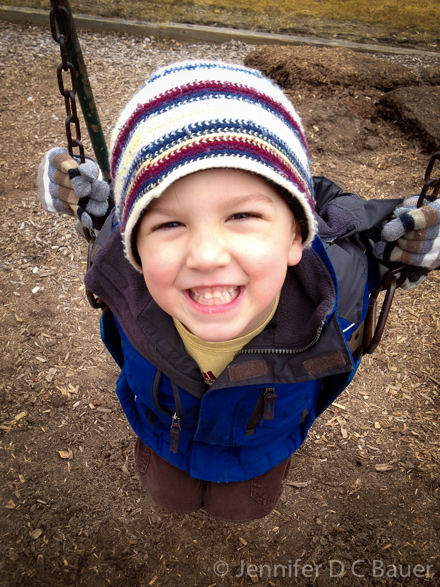 Eoin on the swings at the playground.