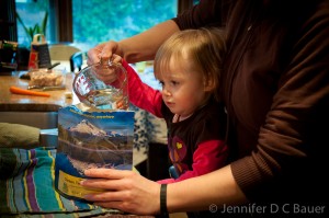 Addie pouring water into the Mountain House Mountain Oven.