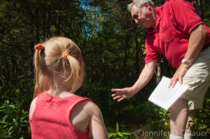 G-Dad showing Addie a dragonfly in Ward Reservation in Andover, MA.
