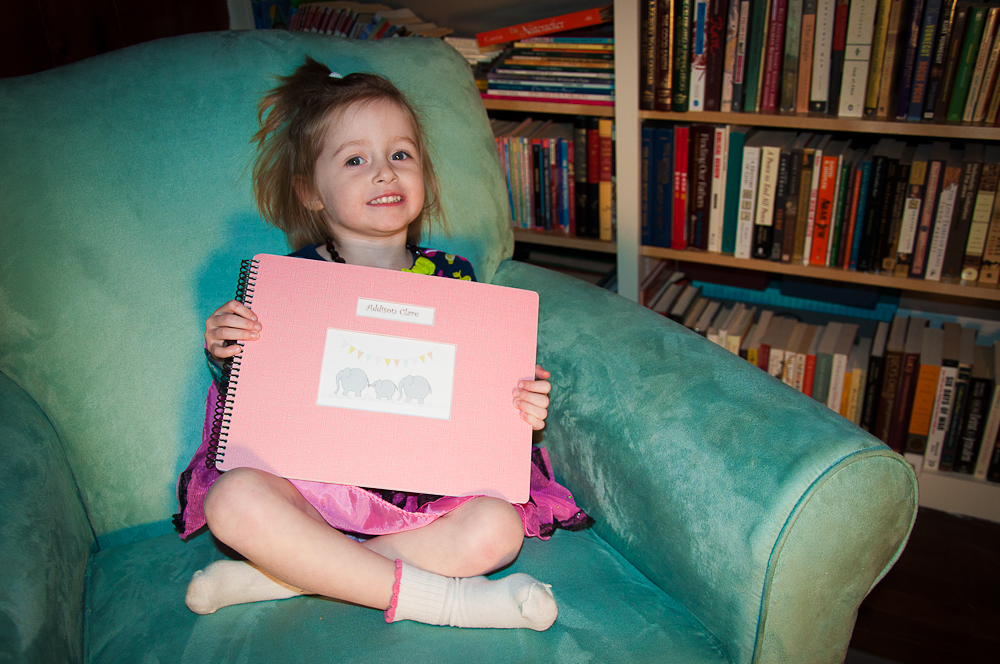 Addie with her Love Leaf baby book